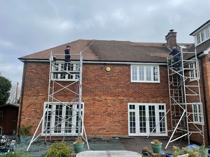 Roof cleaning carried out safely from scaffold towers by The Roof Moss Cleaners in Epsom
